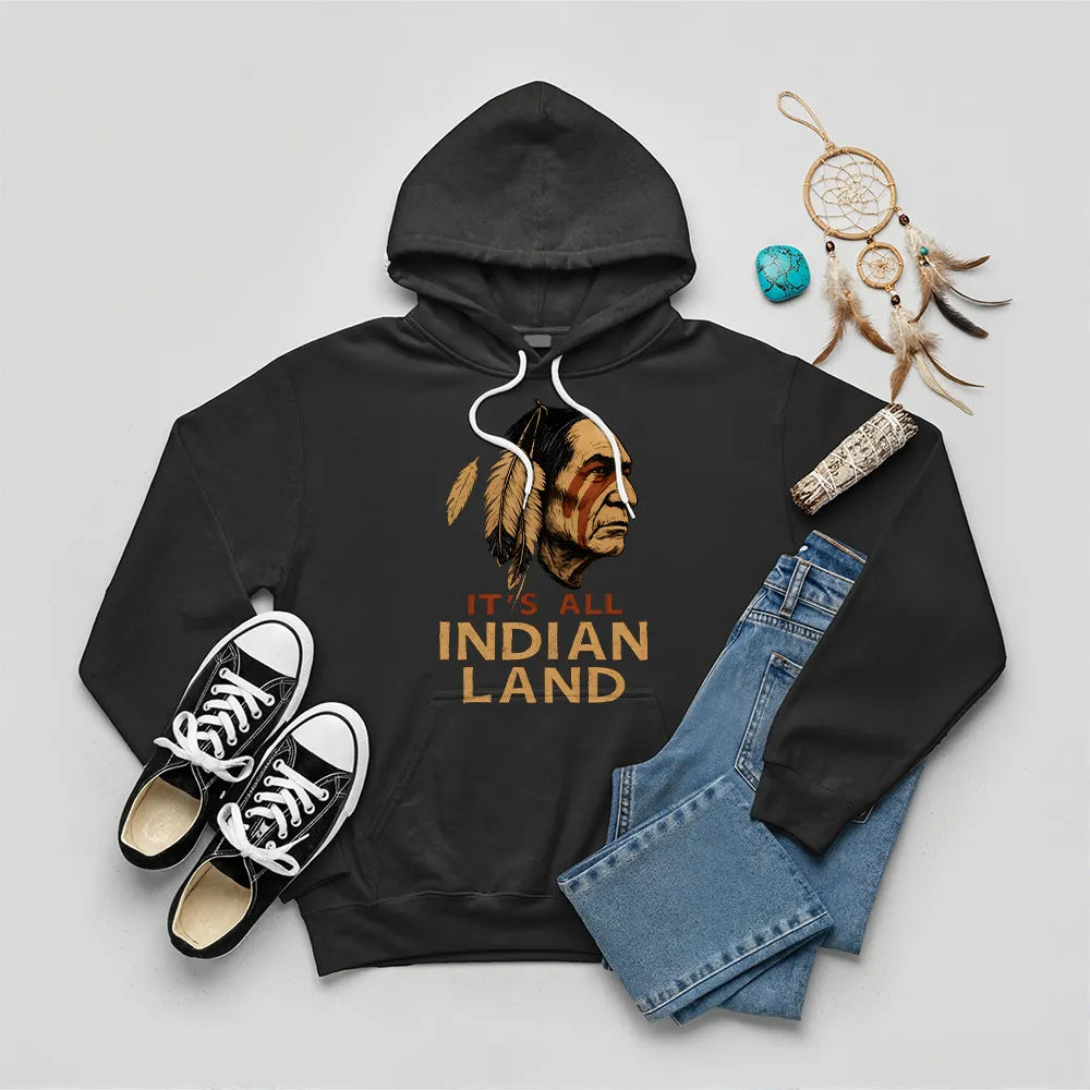 A black hoodie showcasing the "It’s All Indian Land" slogan and Native American headdress design.