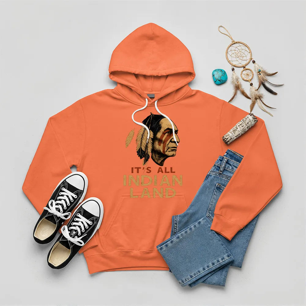 An orange hoodie showcasing the "It’s All Indian Land" slogan and Native American headdress design.
