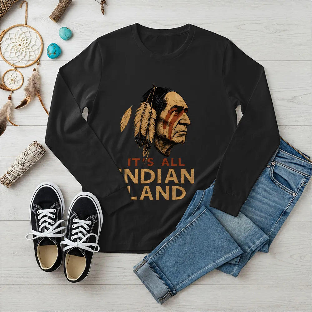 A black long sleeve t-shirt featuring a Native American headdress design with the bold "It’s All Indian Land" slogan.