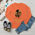 An orange long sleeve t-shirt featuring the 