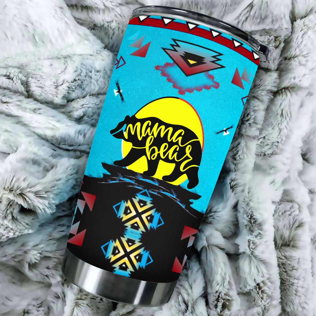 Mama Bear stainless steel tumbler with vibrant blue Native American pattern on a wooden table