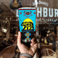 Hand holding Mama Bear tumbler with bright blue and black Native American style pattern, blurred bar background.