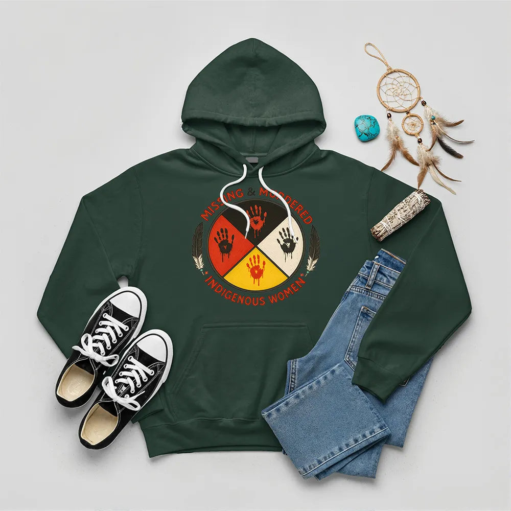 A forest green hoodie showcasing the MMIW awareness design with the red handprint and feathers.