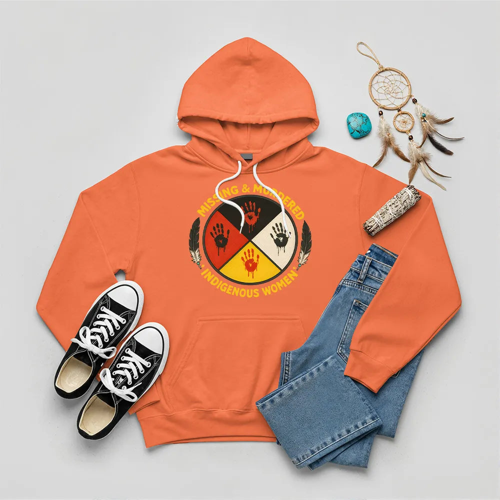 An orange hoodie with the "Missing & Murdered Indigenous Women" graphic, highlighting the red handprint symbol.