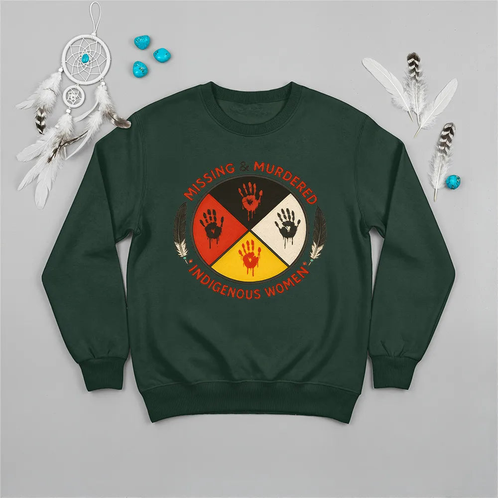 A forest green sweatshirt showcasing the MMIW awareness design with the red handprint and feathers.