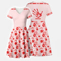 Front and back view of a V-neck A-line dress in soft pink featuring a large red handprint and “MMIW” text.