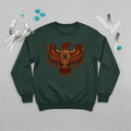 A forest green crewneck sweatshirt with an indigenous-inspired Thunderbird motif, displayed with native accessories on a grey background.