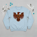 A light blue crewneck sweatshirt with a central Native American Thunderbird artwork, presented with decorative feathers and sage.