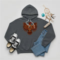 A charcoal slate hoodie with a Native American Thunderbird totem design, paired with jeans and sneakers.