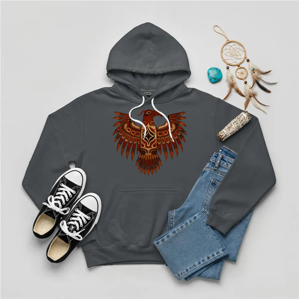 A charcoal slate hoodie with a Native American Thunderbird totem design, paired with jeans and sneakers.