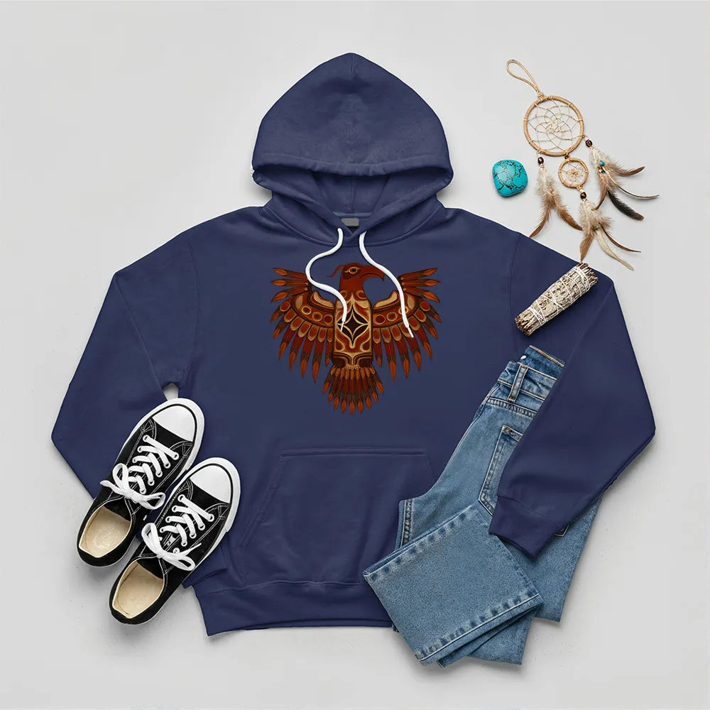 A navy blue hoodie with a Native American Thunderbird totem design, paired with jeans and sneakers.