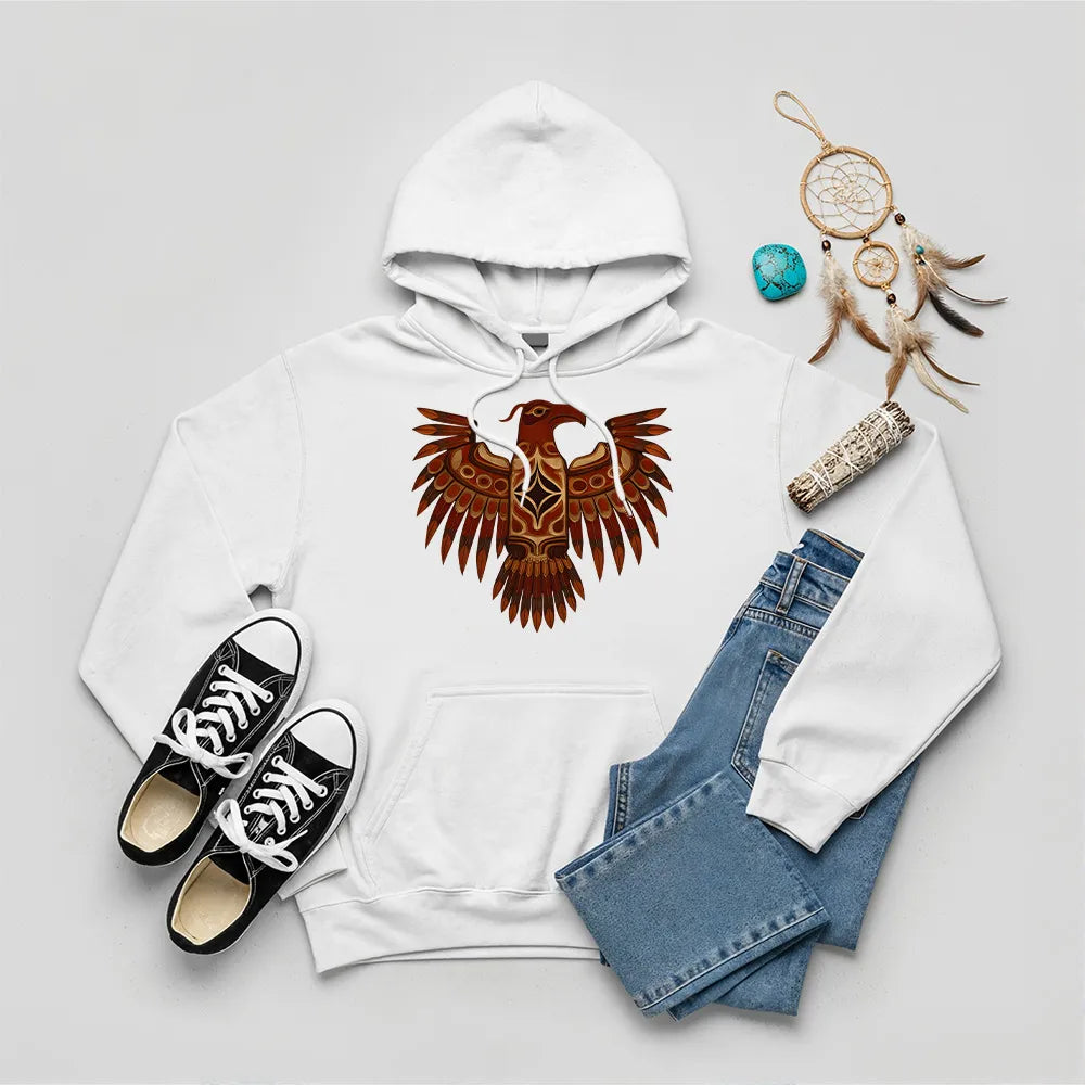 A red hoodie featuring a traditional Native American Thunderbird design, styled with jeans and sneakers.
