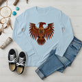 A light blue long-sleeve t-shirt with a central Native American Thunderbird artwork, presented with a casual outfit.