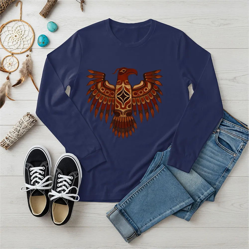 A navy blue long-sleeve t-shirt with a Native American Thunderbird totem design, paired with jeans and sneakers.