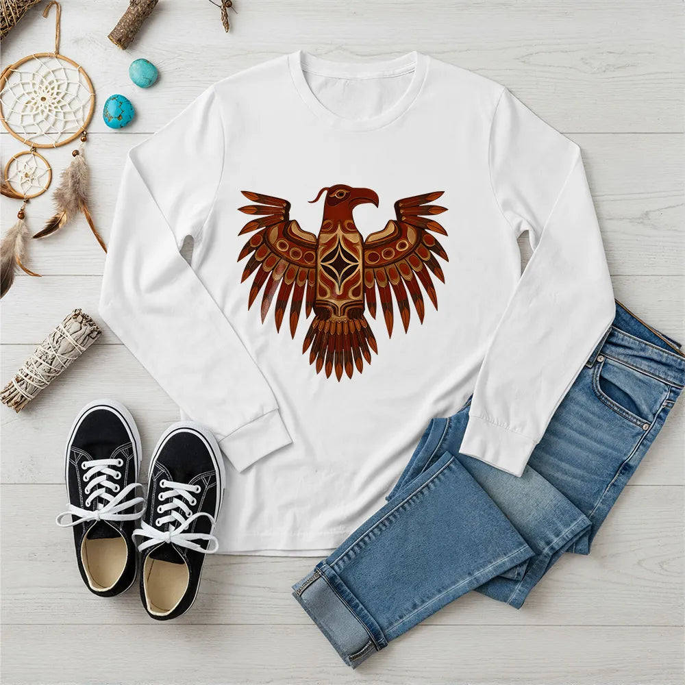 A red long-sleeve t-shirt featuring a traditional Native American Thunderbird design, styled with jeans and sneakers.