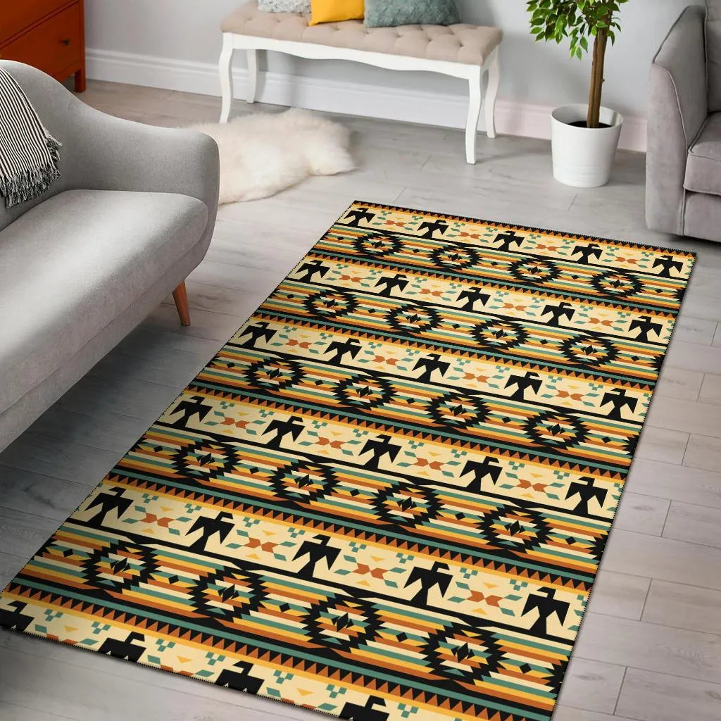 Modern interior space showcasing a rectangular Thunderbird-patterned rug with repeating rows of stylized thunderbird icons and diamond star motifs in warm earth tones.