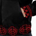 lose-up of fleece jacket cuff with red geometric tribal patterns and detailed stitching