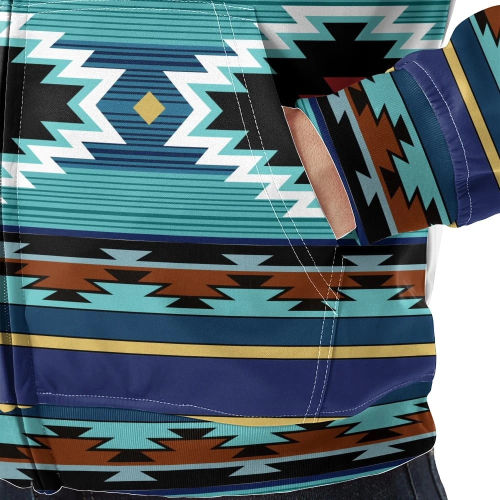 Close-up detail of the jacket’s kangaroo pocket and sleeve cuff, showcasing precise stitching and the vibrant geometric tribal print in turquoise, brown and black.
