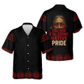 Black camp‑collar button‑up shirt featuring red geometric bands on shoulders and hem; back art includes an elder portrait and “Still Here Still Strong Native Pride” slogan.