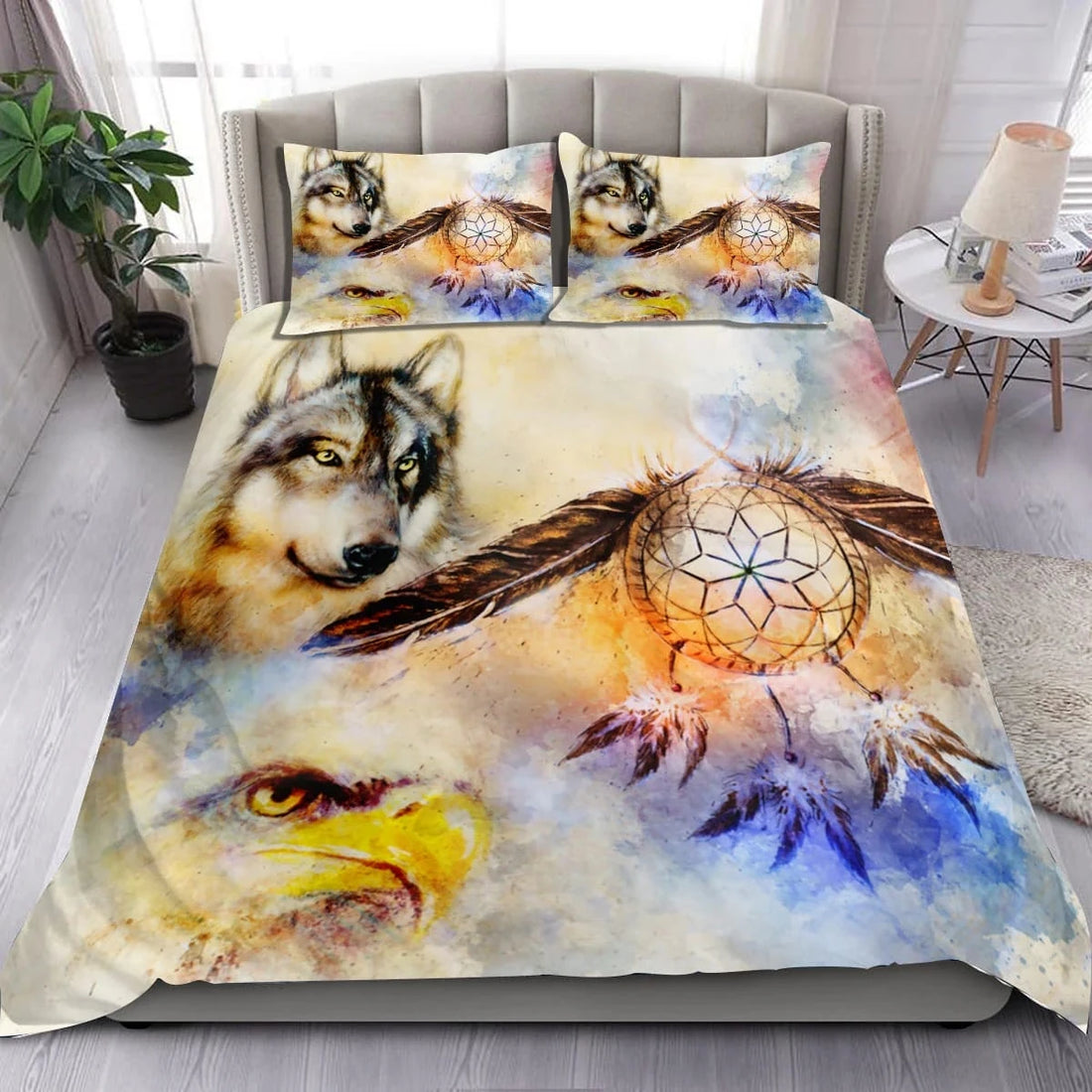 Close-up of Northeast Woodlands Native American dreamcatcher design with wolves and feathers on soft fabric bedding.