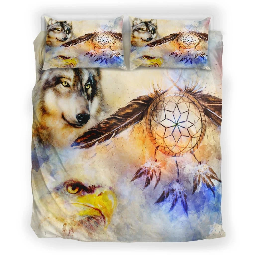 Close-up of Northeast Woodlands Native American dreamcatcher design with wolves and feathers on soft fabric bedding.
