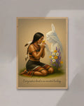 A woman’s hands adjusting a framed Native American art print on a white wall, showing a kneeling tribal woman and her ancestral spirit beside yellow and purple flowers.