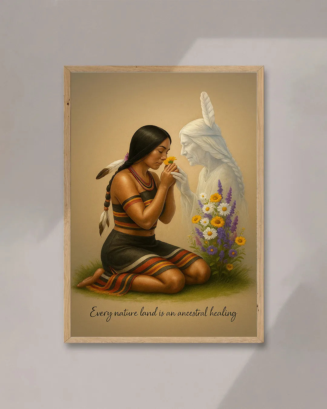 A woman’s hands adjusting a framed Native American art print on a white wall, showing a kneeling tribal woman and her ancestral spirit beside yellow and purple flowers.
