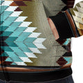 Close-up of the fleece jacket’s kangaroo pocket, highlighting the large turquoise and cream diamond graphic on an olive backdrop, with black cuff and hem trim visible.