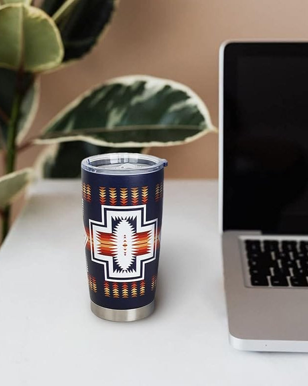 Front and back views of a 20 oz navy insulated tumbler showcasing an orange-red and white Aztec cross design on a plain white background.