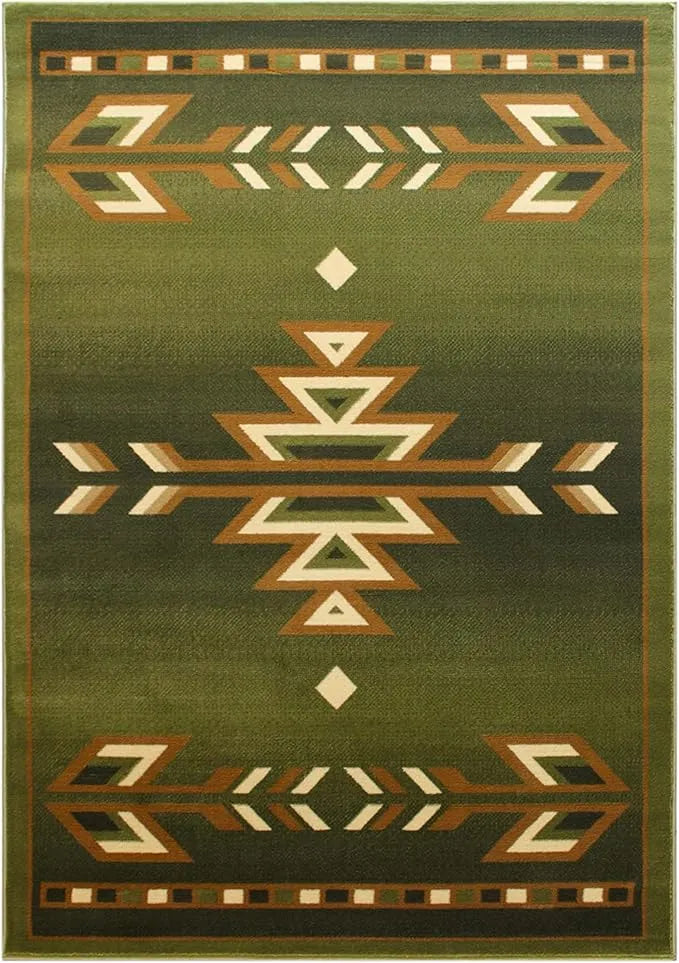 Close-up view of the front edge of the green tribal rug, highlighting the woven texture and ochre-and-cream triangular arrowhead pattern on an olive-green background.