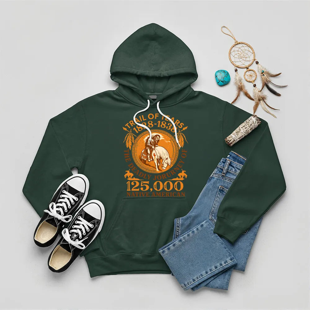 A forest green hoodie featuring the "Trail of Tears" commemorative design, styled with jeans and black sneakers.
