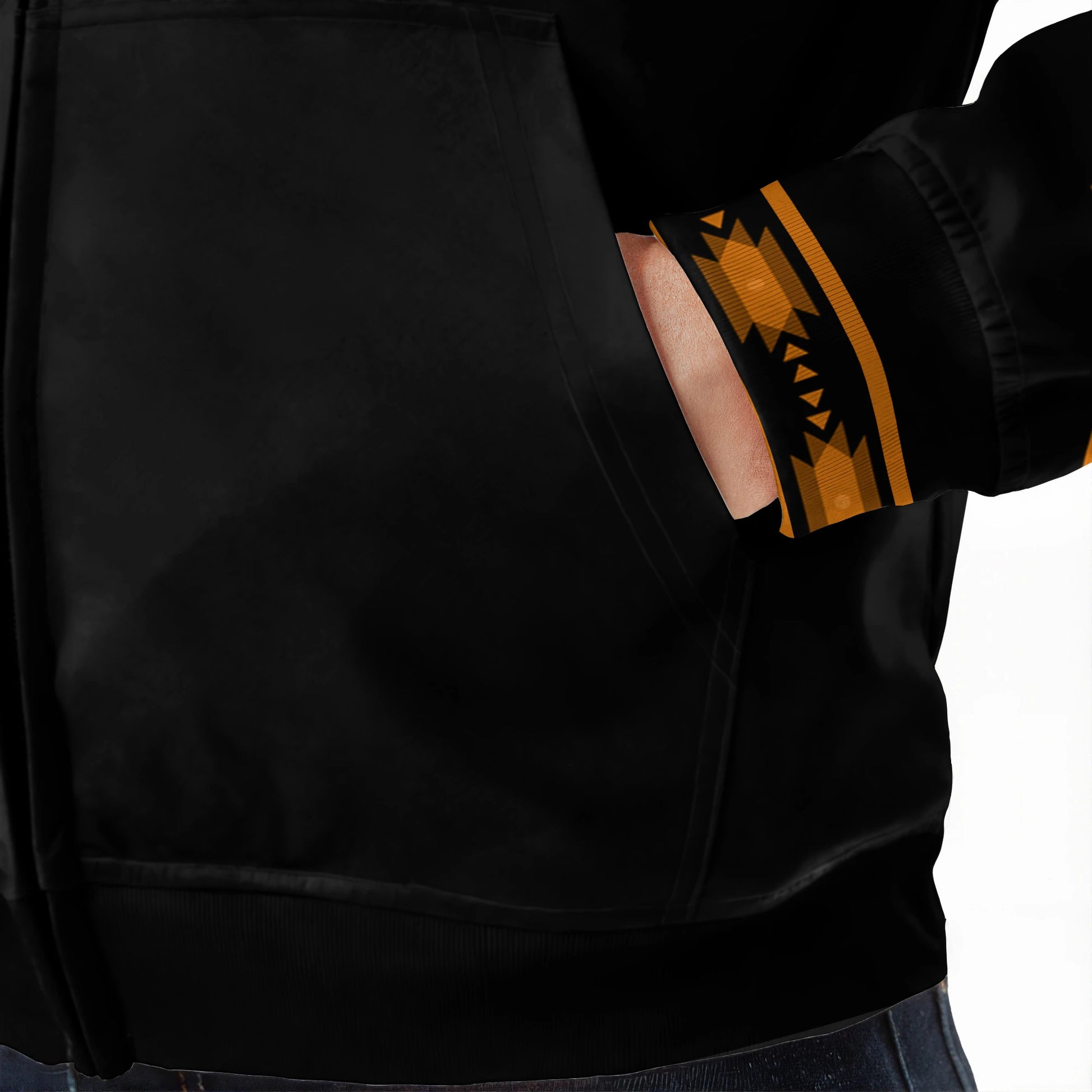 Close-up of Native-inspired tribal patterns in golden tones on hoodie sleeves and hood