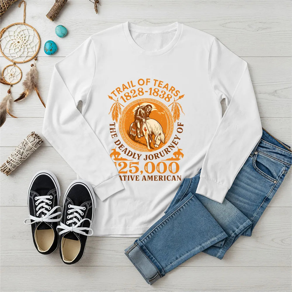 A white long-sleeve t-shirt displaying the "Trail of Tears" historical design, laid flat with traditional Native American inspired accessories.