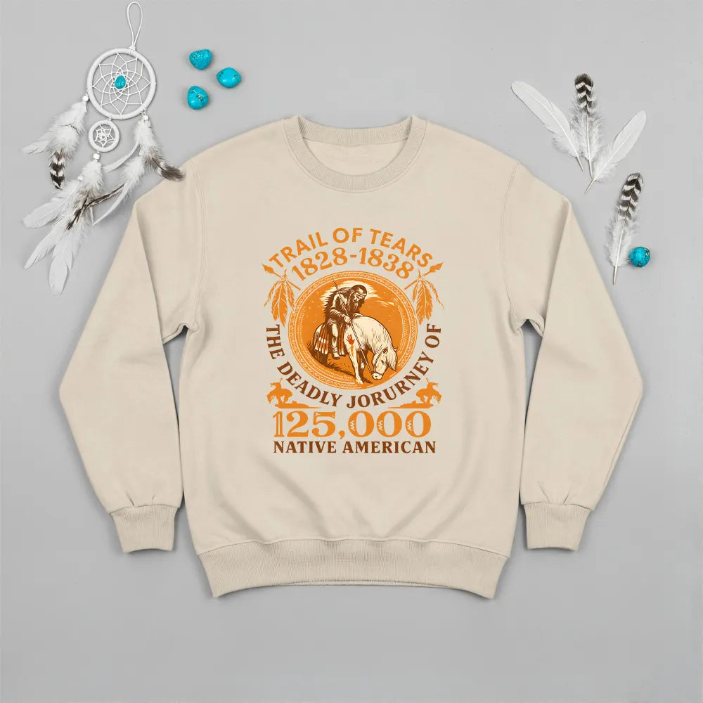 An beige sweatshirt with the "Trail of Tears" graphic, presented with a dreamcatcher and sage bundle.