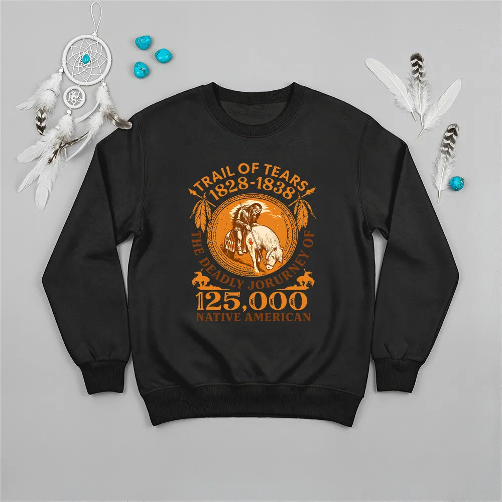 A black sweatshirt featuring the "Trail of Tears 1828-1838 The Deadly Journey of 125,000 Native American" graphic in orange, styled casually.