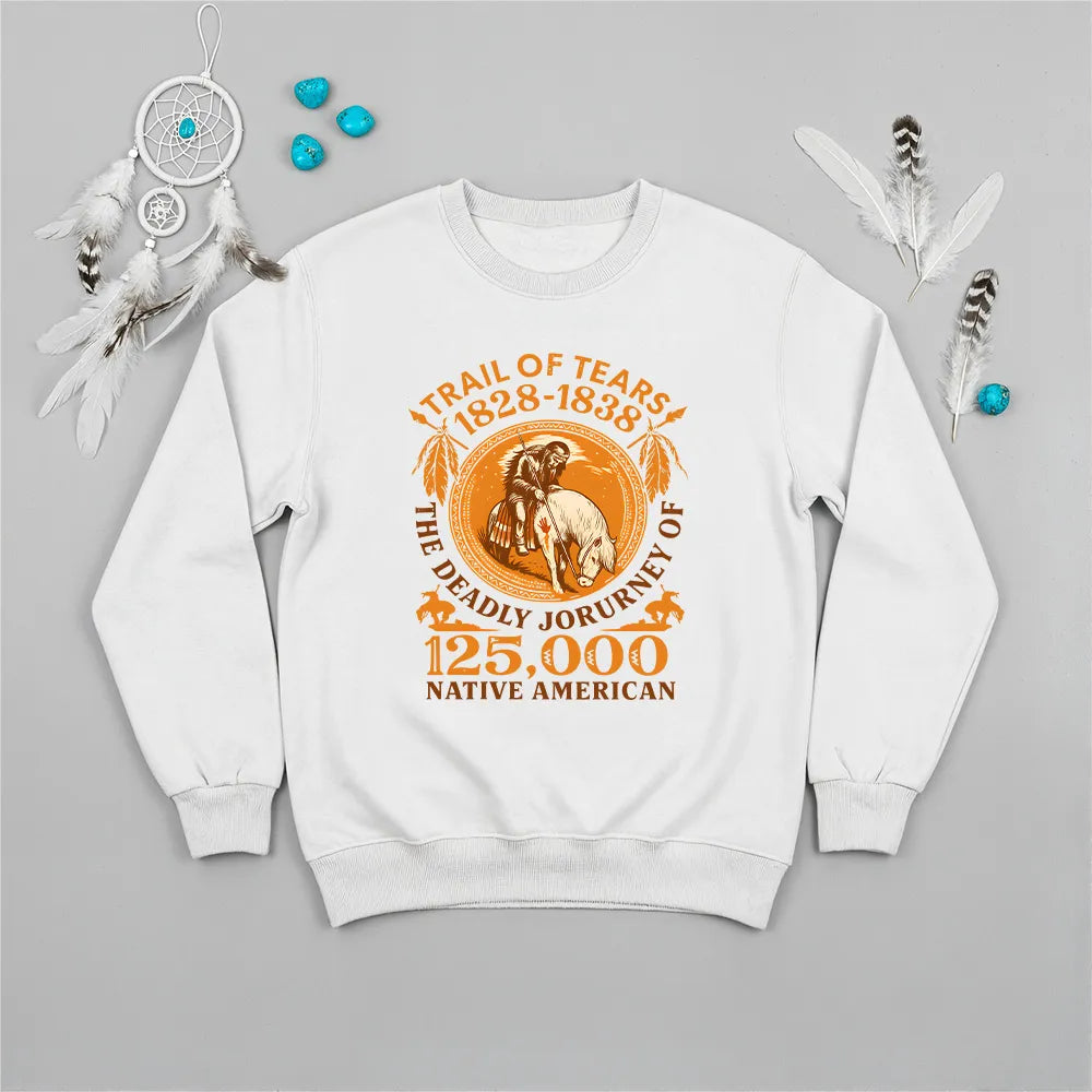 A white sweatshirt with the "Trail of Tears" commemorative design, laid flat with jeans and a leather bag.