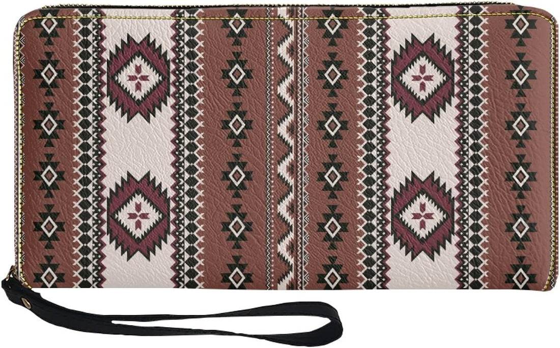Angled shot of the brown tribal-inspired wristlet wallet showing its textured fabric, gold zipper track, and detachable black wrist strap, highlighting the intricate geometric design.