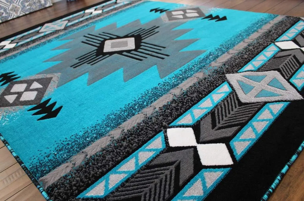 Flat-lay of a turquoise and gray Southwestern Aztec area rug showing its full central geometric medallion and border patterns.